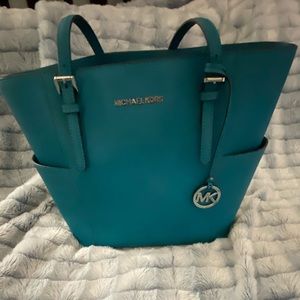 Turquoise and silver Michael Kors tote with two end pockets like new